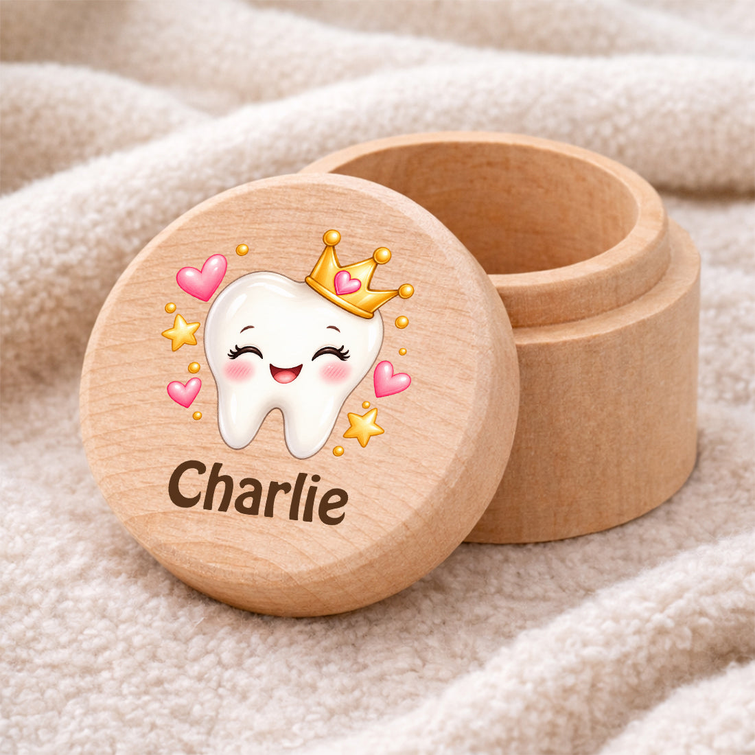 Runde Zahndose mit Motiv Zahnprinzessin und Beispielname Charlie auf einer weichen Decke