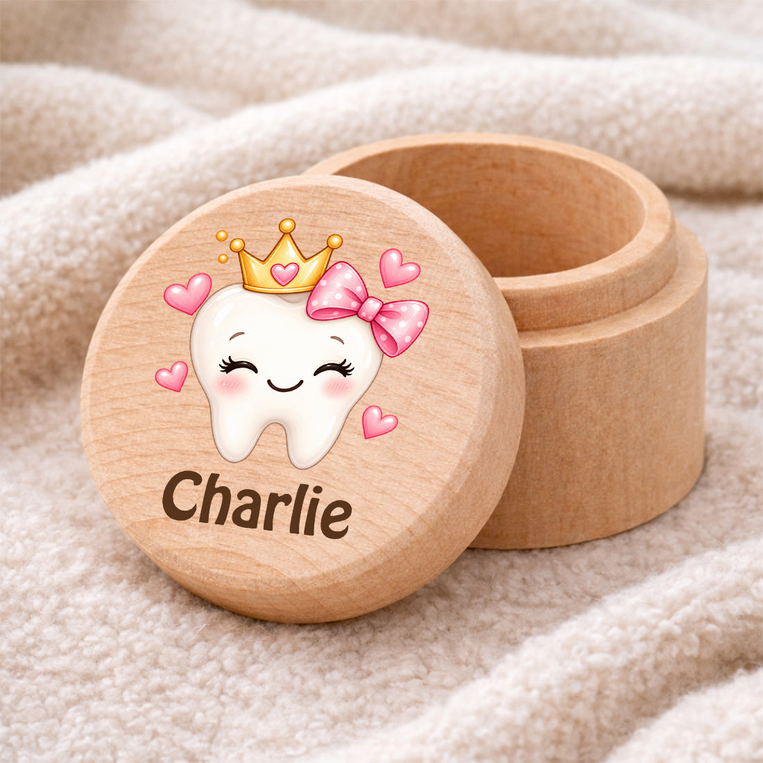 Runde Zahndose mit Motiv Zahnprinzessin mit Schleife und Beispielname Charlie auf einer weichen Decke