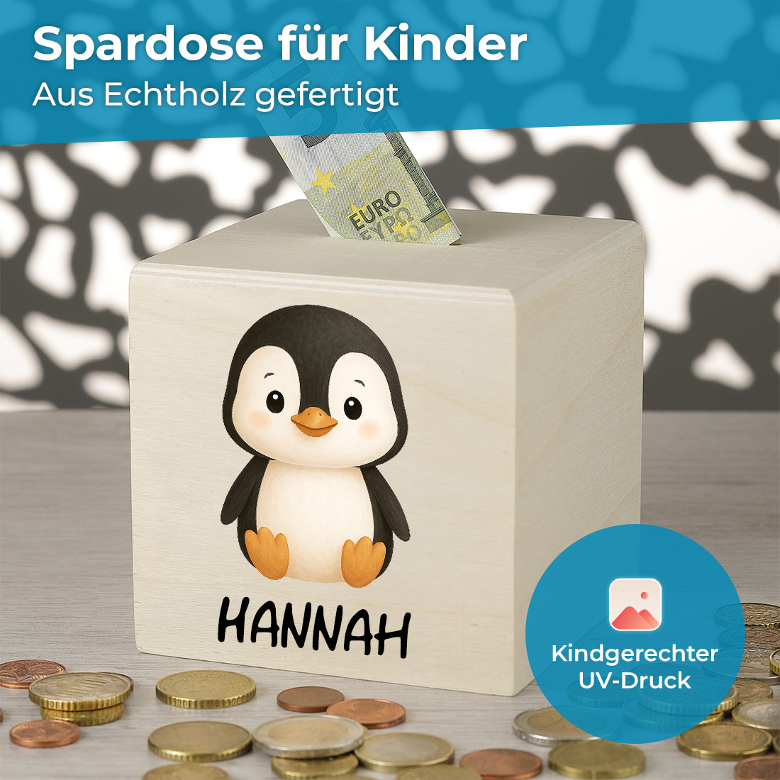 Holzspardose mit Pinguin, Beispielname Hannah, Münzen und Geldschein.